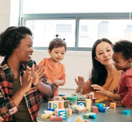 Parents playing with toddlers and preschoolers at YMCA program