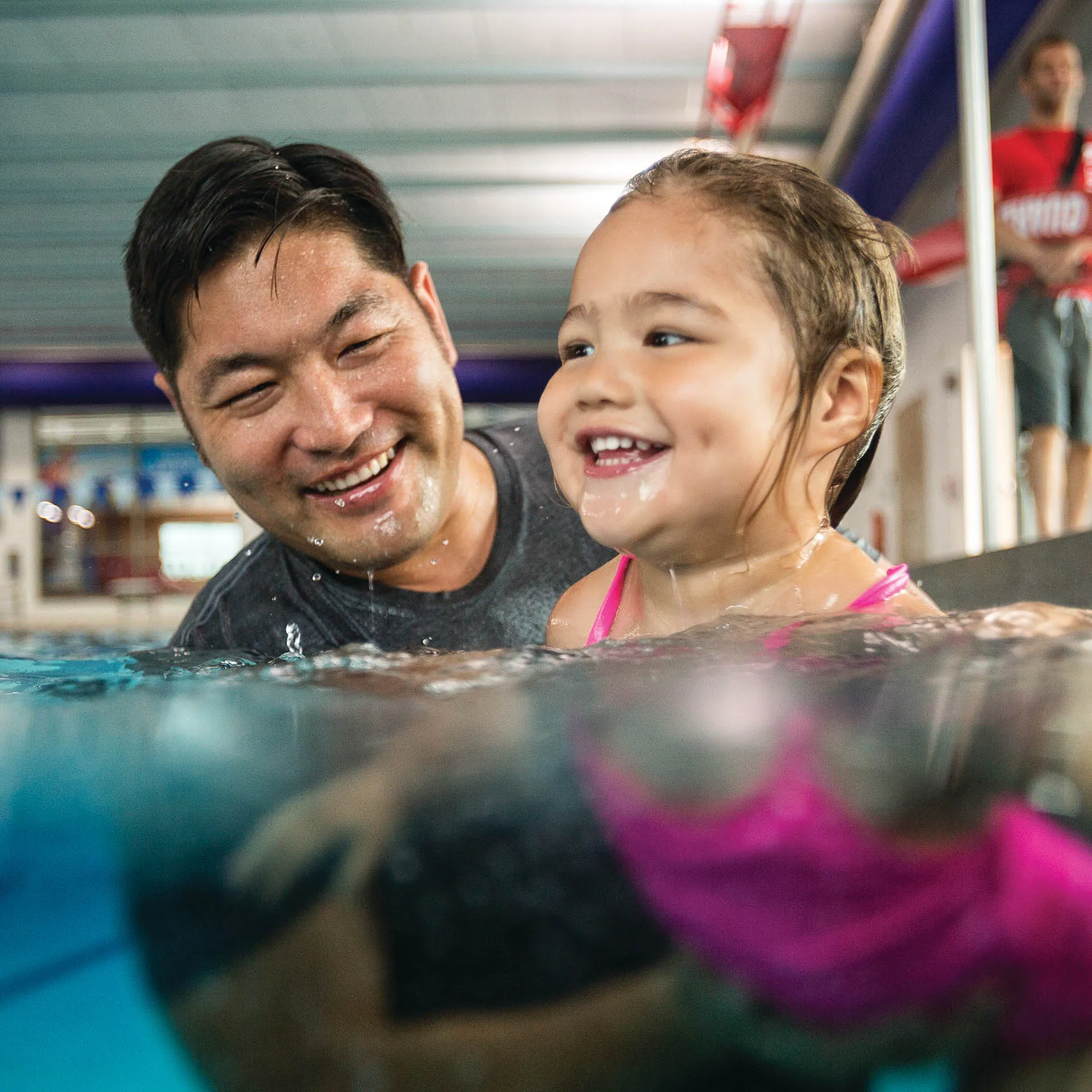 father and daughter swimming