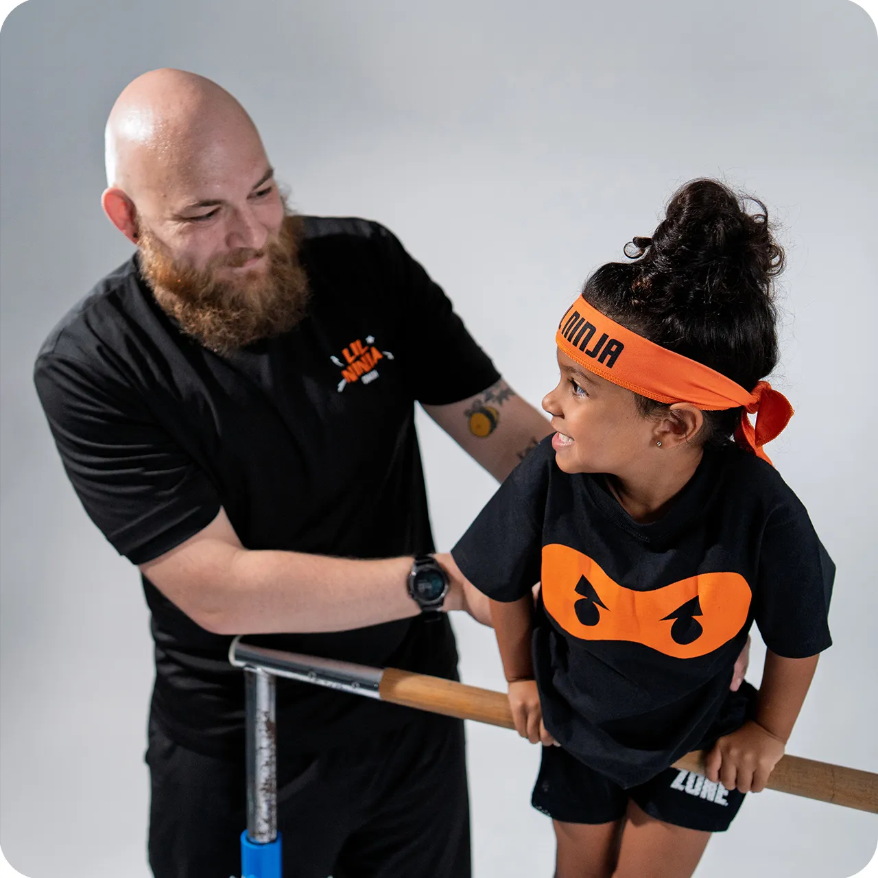 Ninja Zone coach with student on bars