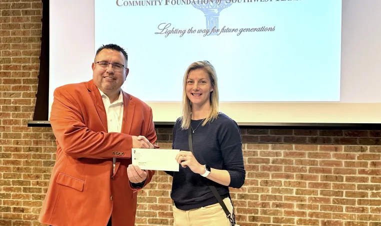 Community Foundation presents check to Jackie Regan-Gaucin, Dodge City Family YMCA CEO